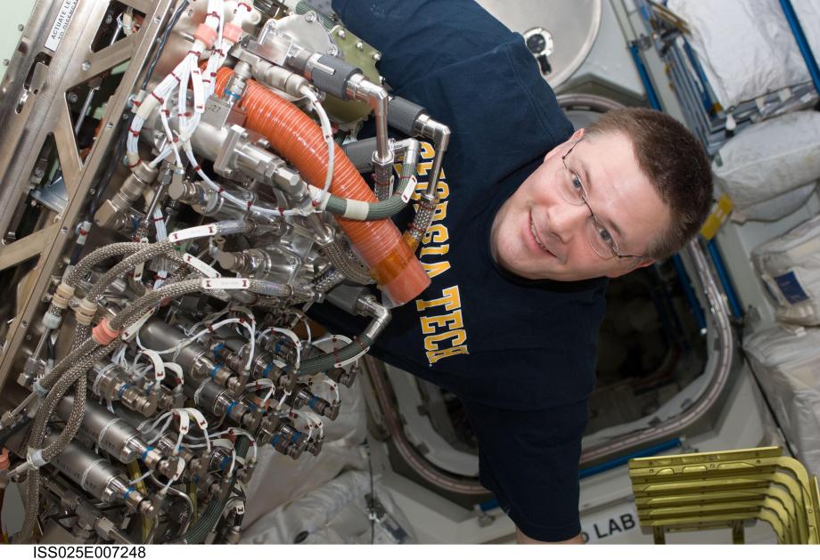 The Sabatier reactor on the ISS, seen here with Doug Wheelock, combines two unwanted gases (hydrogen and carbon dioxide) to produce water for the crew.