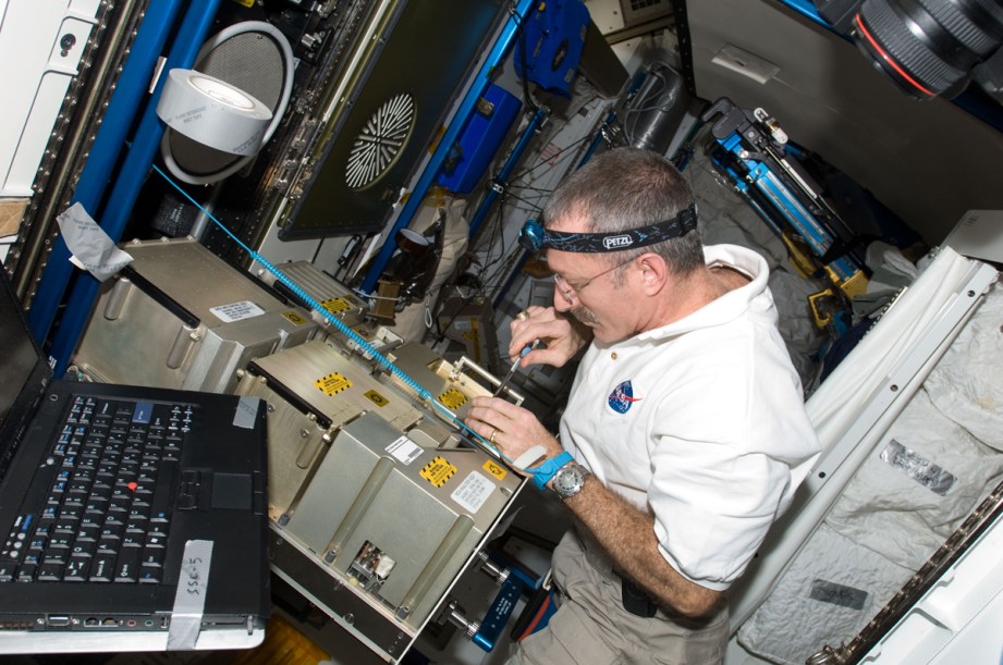Astronaut Dan Burbank works on the mass spectrometer portion of the Major Constituent Analyzer, a tool that identifies the gasses that are present in the ISS's atmosphere.